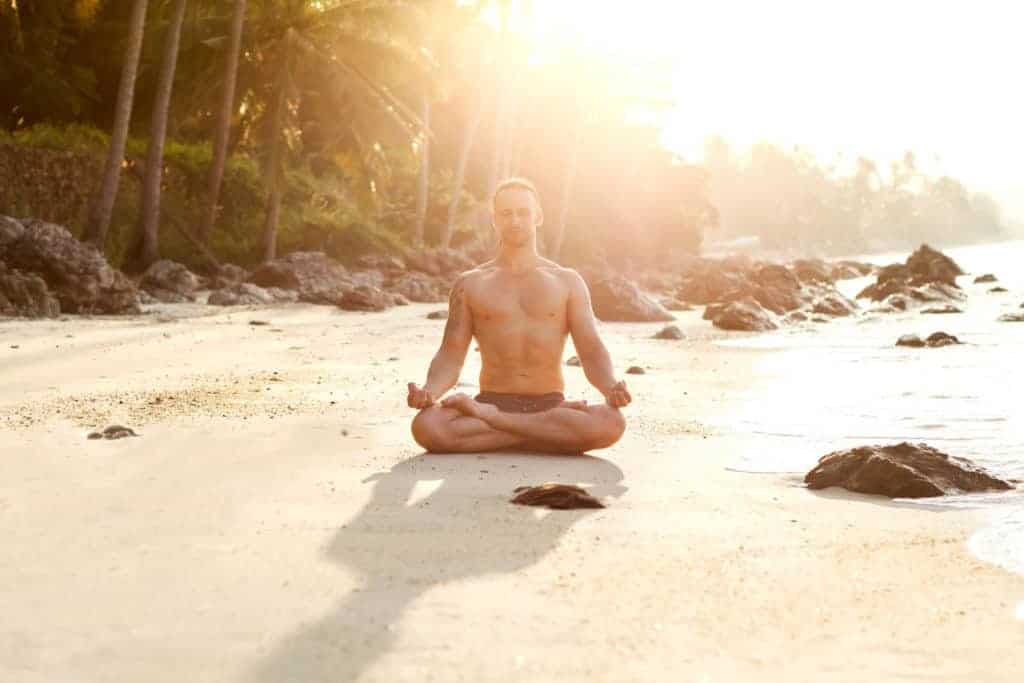 PranaOn man meditating on a beach